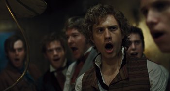 Movie still from “Les Misérables” (2012), directed by Tom Hooper – A group of men standing next to each other; Close Up shot, Over the shoulder angle