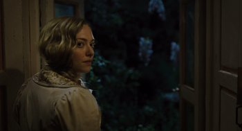 Movie still from “Les Misérables” (2012), directed by Tom Hooper – A woman standing in front of a window at night; Close Up shot, Over the shoulder angle
