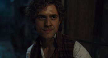 Movie still from “Les Misérables” (2012), directed by Tom Hooper – A person wearing a shirt and vest; Close Up shot, Over the shoulder angle