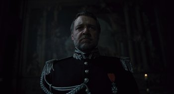 Movie still from “Les Misérables” (2012), directed by Tom Hooper – A person wearing a uniform; Medium shot, Low angle