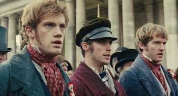 Movie still from “Les Misérables” (2012), directed by Tom Hooper – Two men wearing hats and a red scarf; Close Up shot, Low angle