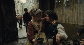 Movie still from “Les Misérables” (2012), directed by Tom Hooper – A man and a woman kissing on the street; Medium shot, Over the shoulder angle