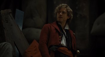 Movie still from “Les Misérables” (2012), directed by Tom Hooper – A man wearing a red jacket and a white shirt; Close Up shot, Over the shoulder angle