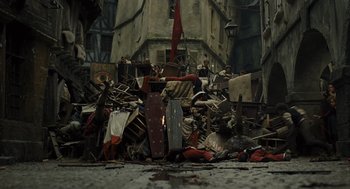 Movie still from “Les Misérables” (2012), directed by Tom Hooper – A pile of debris in the middle of a street; Extreme Wide shot, High angle