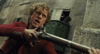 Movie still from “Les Misérables” (2012), directed by Tom Hooper – A man holding a gun in his hand; Close Up shot, Low angle