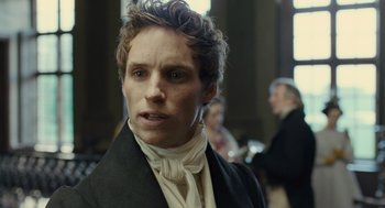 Movie still from “Les Misérables” (2012), directed by Tom Hooper – A person wearing a suit and tie; Close Up shot, Over the shoulder angle