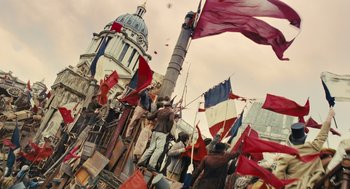Movie still from “Les Misérables” (2012), directed by Tom Hooper – A group of people standing on top of a building; Extreme Wide shot, Low angle