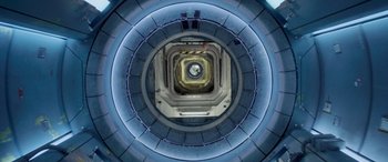 Movie still from “Life” (2017), directed by Daniel Espinosa – Looking down at a spiral staircase in a building; Extreme Wide shot, Overhead angle