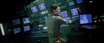 Movie still from “Life” (2017), directed by Daniel Espinosa – A man in a military uniform in front of a wall of monitors; Medium shot, Over the shoulder angle