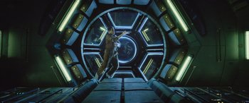 Movie still from “Life” (2017), directed by Daniel Espinosa – A man is jumping in the air inside a spaceship; Wide shot, Overhead angle