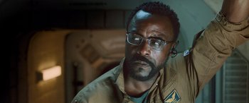 Movie still from “Life” (2017), directed by Daniel Espinosa – A person wearing glasses and a jacket; Close Up shot, Over the shoulder angle