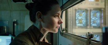 Movie still from “Life” (2017), directed by Daniel Espinosa – A woman looking out of a window on a train; Close Up shot, Low angle