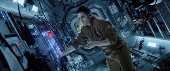 Movie still from “Life” (2017), directed by Daniel Espinosa – A man standing in front of a computer screen; Medium shot, Low angle