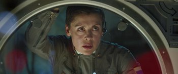 Movie still from “Life” (2017), directed by Daniel Espinosa – A person with a headset on looking at the camera; Close Up shot, Low angle