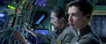 Movie still from “Life” (2017), directed by Daniel Espinosa – A man in a military uniform is looking at a computer screen; Close Up shot, Over the shoulder angle