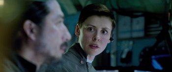 Movie still from “Life” (2017), directed by Daniel Espinosa – A person with a headset on looking at something; Close Up shot, Over the shoulder angle