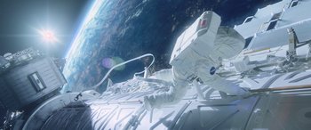 Movie still from “Life” (2017), directed by Daniel Espinosa – An image of an astronaut on a spacewalk in space; Wide shot, Overhead angle