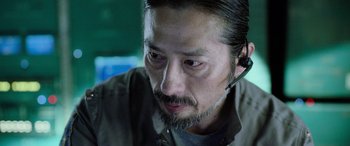 Movie still from “Life” (2017), directed by Daniel Espinosa – A person wearing a headset; Close Up shot, Low angle