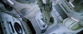 Movie still from “Life” (2017), directed by Daniel Espinosa – A man in a space suit hanging from the side of a building; Wide shot, Overhead angle