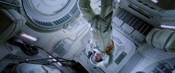 Movie still from “Life” (2017), directed by Daniel Espinosa – A man hanging from the side of a tall building; Wide shot, Overhead angle