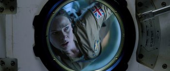 Movie still from “Life” (2017), directed by Daniel Espinosa – A woman is looking into a round mirror; Close Up shot, Overhead angle