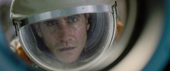 Movie still from “Life” (2017), directed by Daniel Espinosa – A person wearing a helmet; Close Up shot, Overhead angle