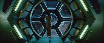 Movie still from “Life” (2017), directed by Daniel Espinosa – A man standing inside of a space station; Wide shot, Overhead angle