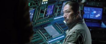 Movie still from “Life” (2017), directed by Daniel Espinosa – A man with a beard is standing in front of a computer screen; Close Up shot, Over the shoulder angle