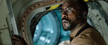 Movie still from “Life” (2017), directed by Daniel Espinosa – A person wearing glasses; Close Up shot, Low angle