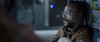 Movie still from “Life” (2017), directed by Daniel Espinosa – A person wearing glasses and a brown jacket; Close Up shot, Low angle