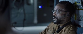 Movie still from “Life” (2017), directed by Daniel Espinosa – A man sitting in front of a window; Close Up shot, Low angle