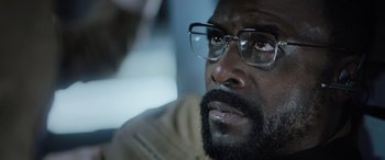 Movie still from “Life” (2017), directed by Daniel Espinosa – A person wearing glasses; Close Up shot, Low angle