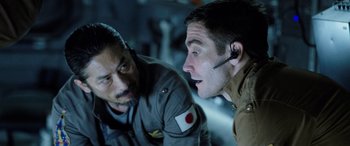 Movie still from “Life” (2017), directed by Daniel Espinosa – Two men are talking to each other in a dark room; Close Up shot, Over the shoulder angle