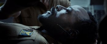 Movie still from “Life” (2017), directed by Daniel Espinosa – A person laying down with a beard; Close Up shot, Overhead angle