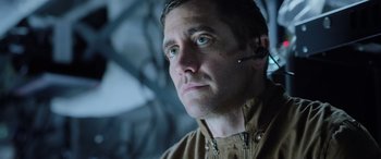 Movie still from “Life” (2017), directed by Daniel Espinosa – A person wearing a headset; Close Up shot, Low angle