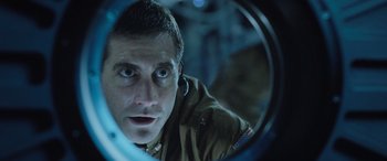 Movie still from “Life” (2017), directed by Daniel Espinosa – A person looking at a mirror; Close Up shot, Over the shoulder angle