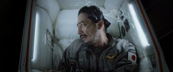 Movie still from “Life” (2017), directed by Daniel Espinosa – A man with a beard is sitting in a bed; Close Up shot, Overhead angle