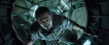 Movie still from “Life” (2017), directed by Daniel Espinosa – A person wearing a shirt; Close Up shot, Overhead angle