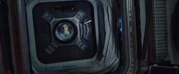Movie still from “Life” (2017), directed by Daniel Espinosa – A picture of a person in a space station; Medium shot, Overhead angle