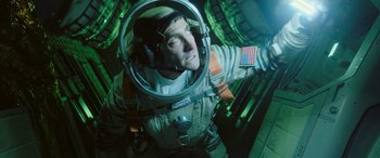 Movie still from “Life” (2017), directed by Daniel Espinosa – A man in a spacesuit is looking up at the sky; Medium shot, Overhead angle