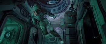 Movie still from “Life” (2017), directed by Daniel Espinosa – A person in a space suit in an outer space station; Wide shot, Overhead angle