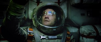 Movie still from “Life” (2017), directed by Daniel Espinosa – A man wearing a space suit and a helmet; Close Up shot, Overhead angle