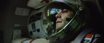 Movie still from “Life” (2017), directed by Daniel Espinosa – A person wearing a space helmet; Close Up shot, Overhead angle