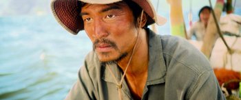 Movie still from “Life” (2017), directed by Daniel Espinosa – A person wearing a hat; Close Up shot, High angle