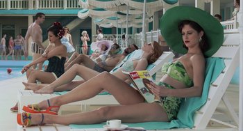 Movie still from “Life of Pi” (2012), directed by Ang Lee – A group of women sitting on lounge chairs reading magazines; Wide shot, Low angle