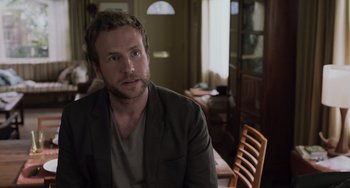 Movie still from “Life of Pi” (2012), directed by Ang Lee – A person sitting at a table in a room; Close Up shot, Over the shoulder angle