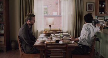 Movie still from “Life of Pi” (2012), directed by Ang Lee – Two people sitting at a table with food on it; Medium shot, Over the shoulder angle