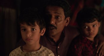 Movie still from “Life of Pi” (2012), directed by Ang Lee – A man and a boy are looking at the camera; Close Up shot, Over the shoulder angle
