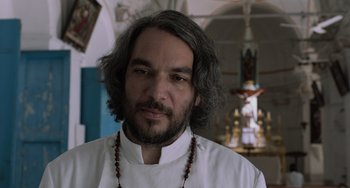 Movie still from “Life of Pi” (2012), directed by Ang Lee – A person with long hair and a beard; Close Up shot, Low angle