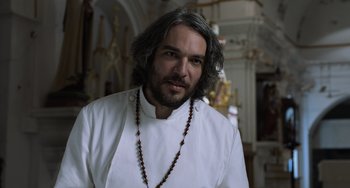 Movie still from “Life of Pi” (2012), directed by Ang Lee – A person with a beard wearing a white shirt; Close Up shot, Low angle